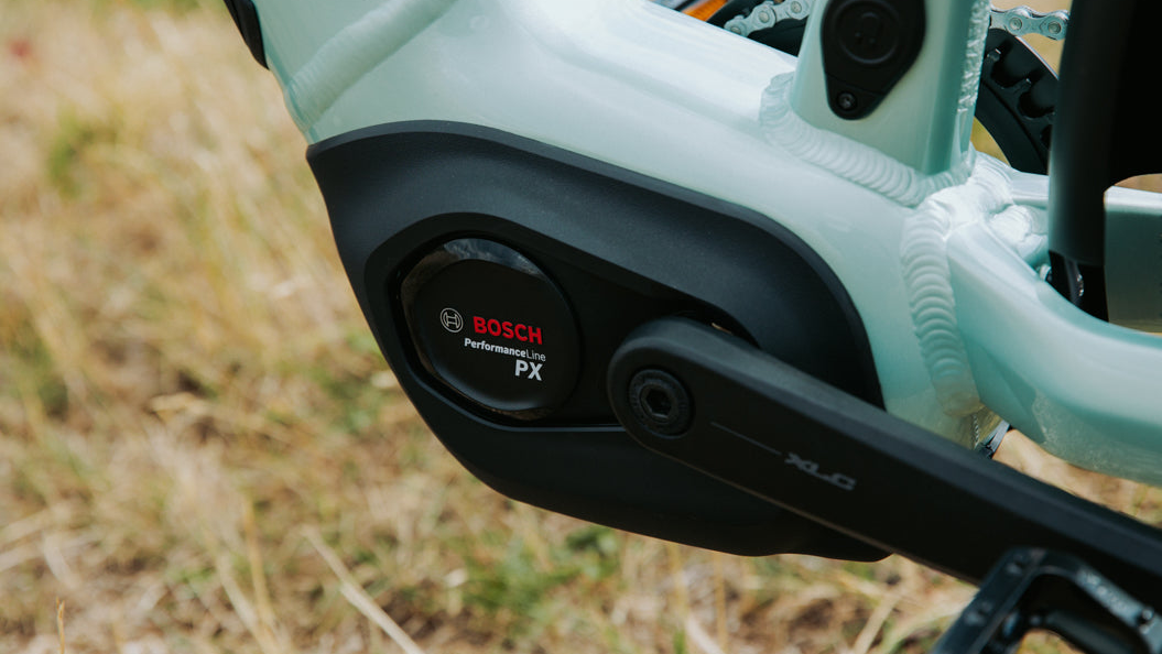Close-up of a bicycle chain and gear system with Bosch branding.