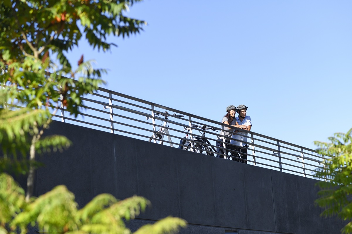 Couple on bridge with helmets